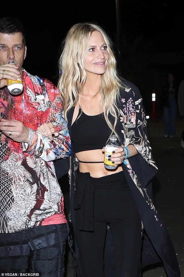 Fun: Poppy partied at Coachella's Neon Carnival with a mystery man on Sunday
