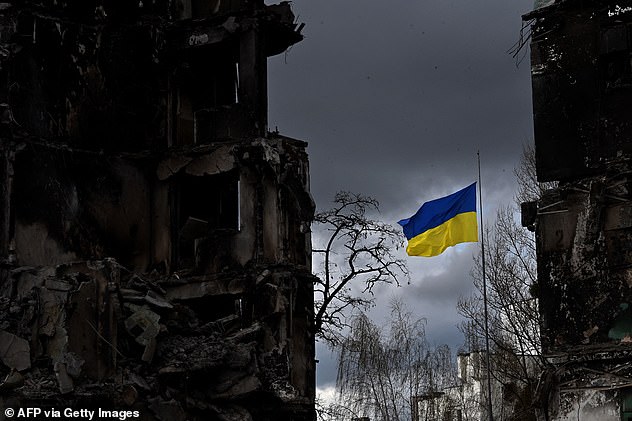 The Ukrainian flag flutters between buildings destroyed in bombardment, in the Ukrainian town of Borodianka, in the Kyiv region on April 17, 2026