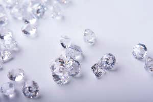 Diamond with tweezers and magnifier.Gemstone Beauty ; Shutterstock ID 1928999420; purchase_order: -; job: -; client: -; other: -