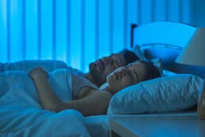 A sleeping man and woman in bed